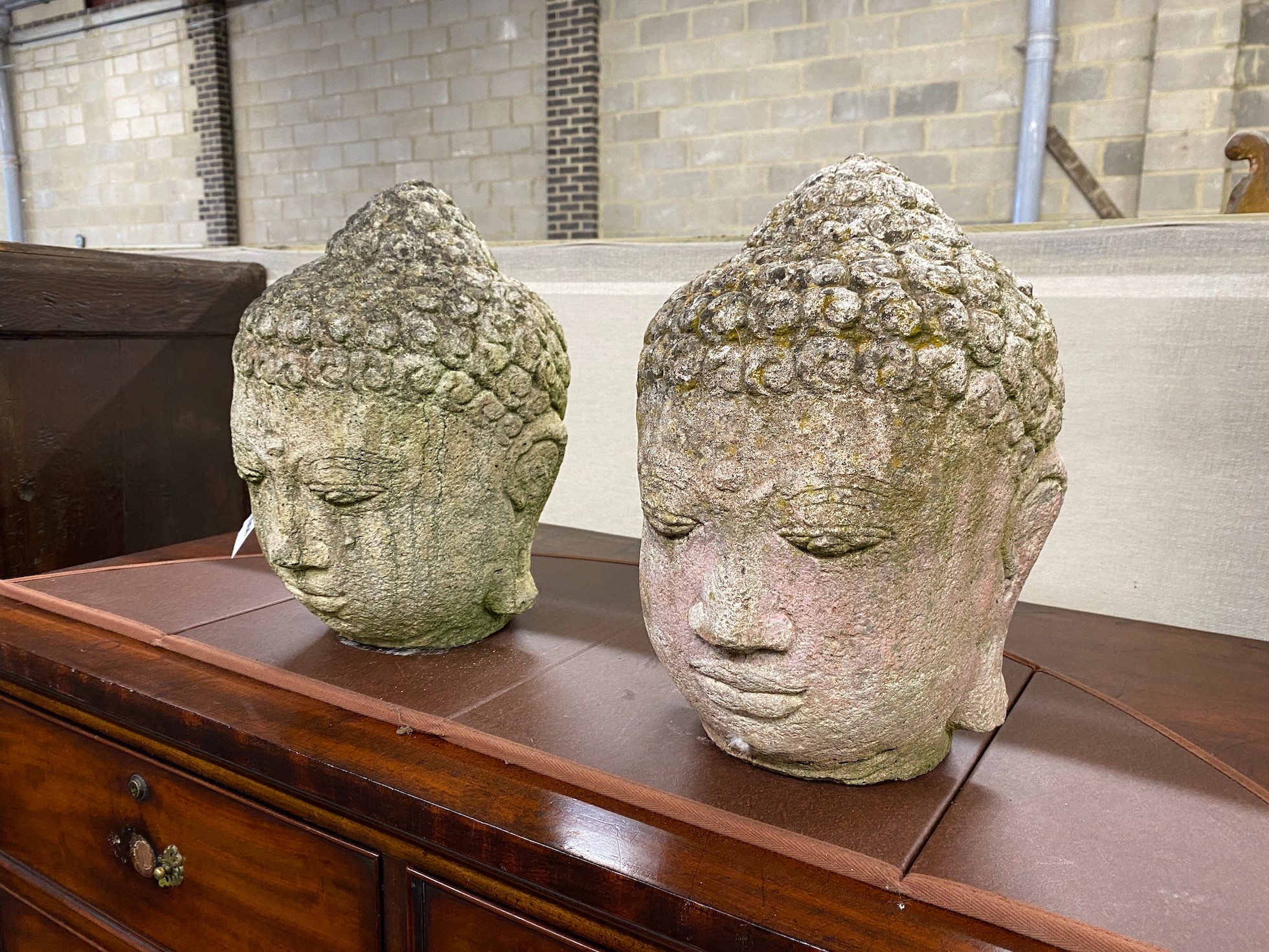 A pair of reconstituted stone 'Buddha' heads, height 35cm